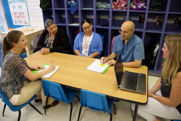 Several adults at a conference table.