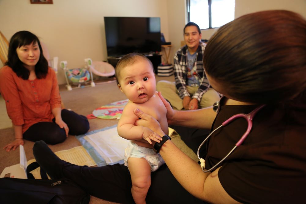 Infant being examinined.