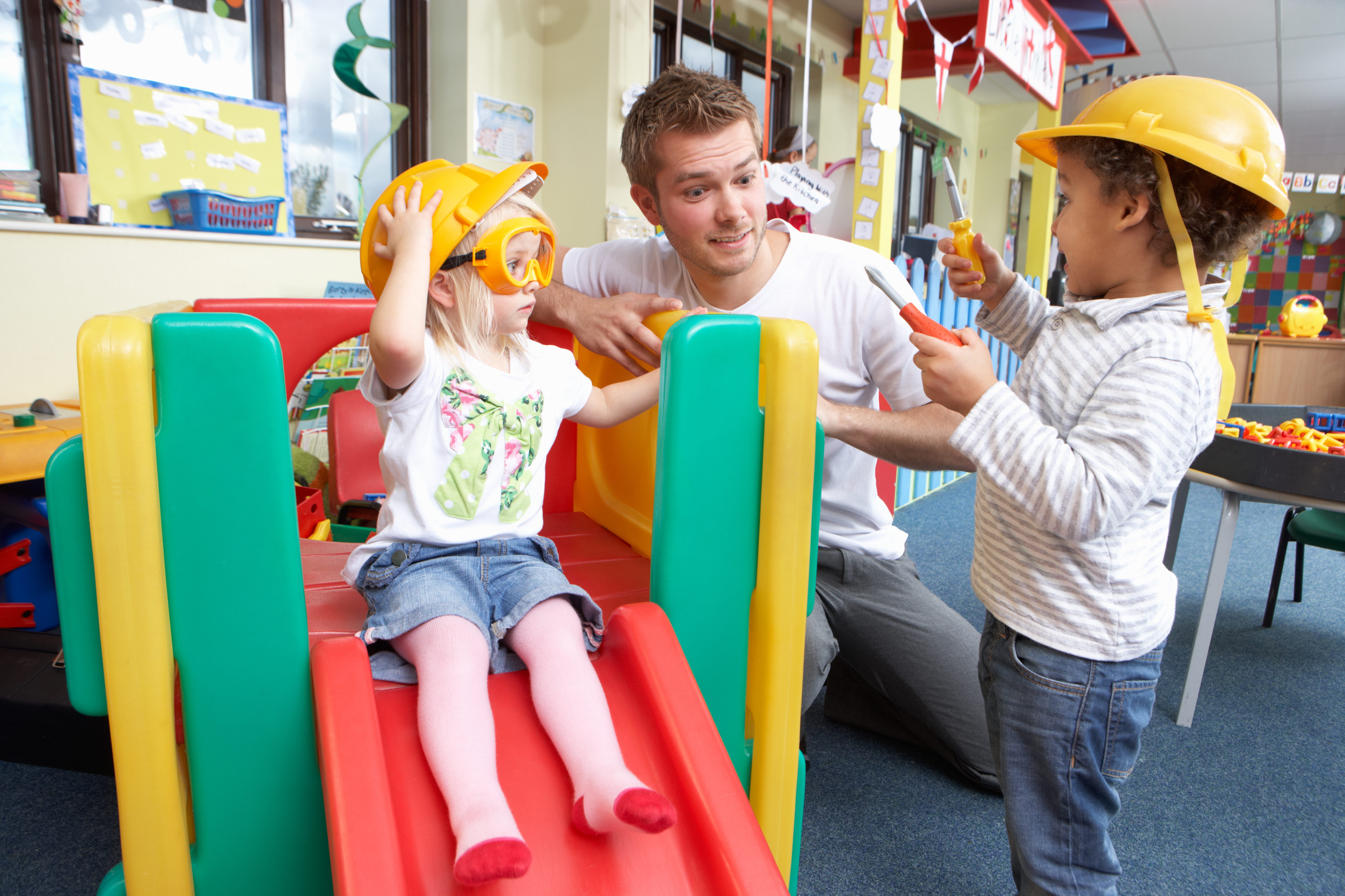 Children playing on an indoor slide.