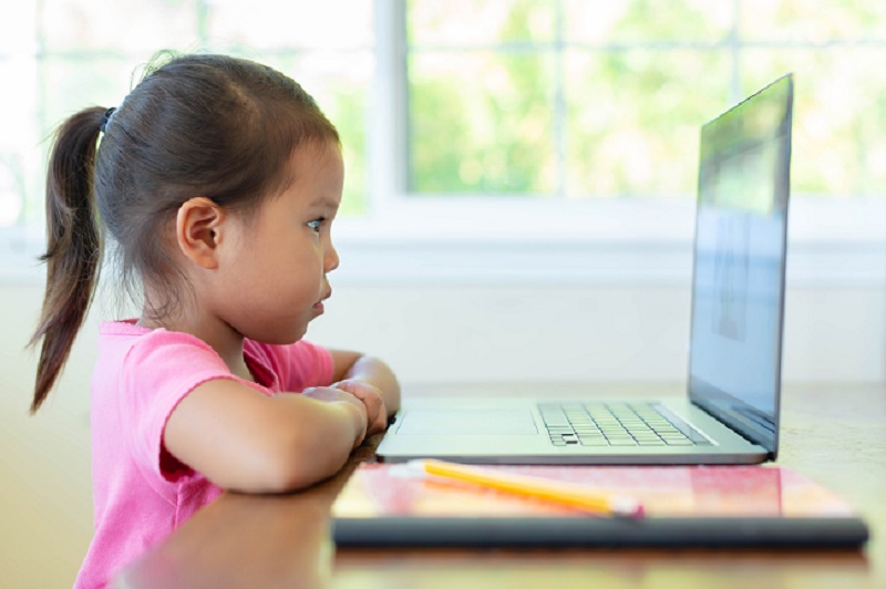 Preschool child watching a virtual classroom