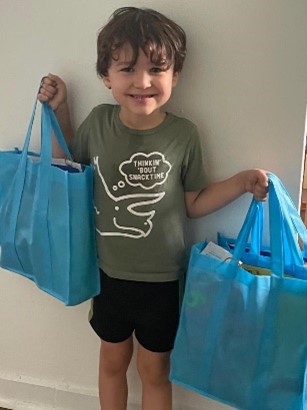 Child handling two bags.