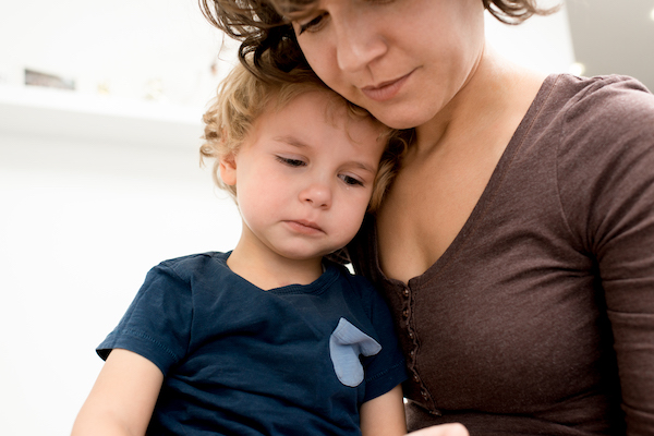 Mother holding and comforting child.