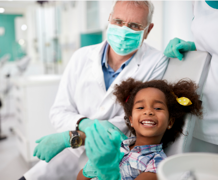 Young girl sitting in the dentist chair having her teeth examined.