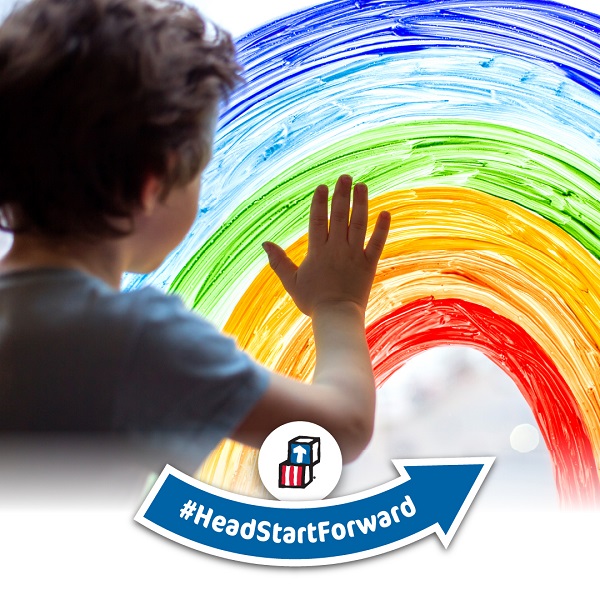 Social media image displaying a child touching a painted rainbow.