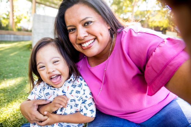 Smiling mother with her child taking a selfie photograph.