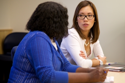 Two women at a table talking.