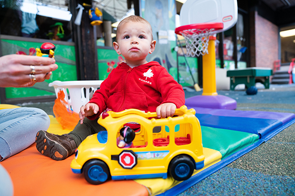 Child playing with a bus toy.