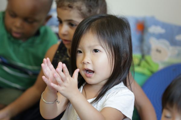 Young girl clapping her hands.