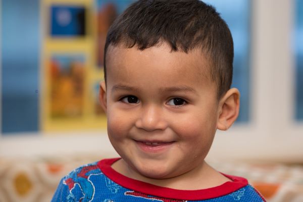 Smiling young boy in a class setting.