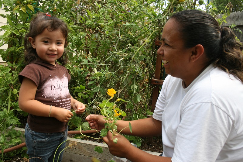 Mother and child gathering some flowers.