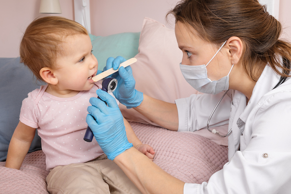 Dental staff examing a child's teeth.