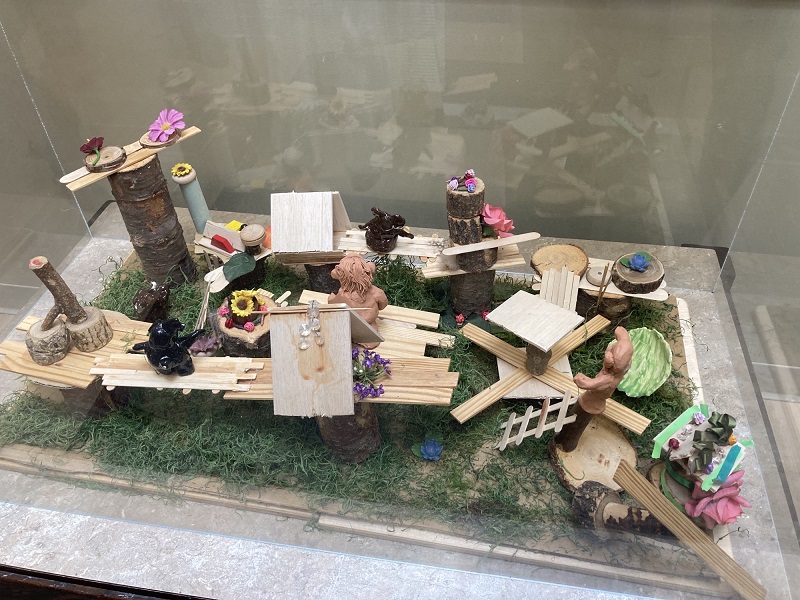 Art created by children and displayed on a table.