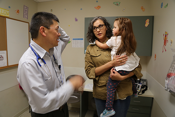 Mother visiting the doctor with her child.