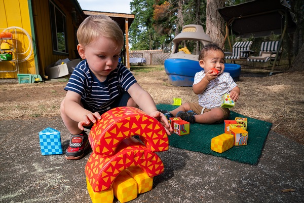 Two young children playing outdoors.