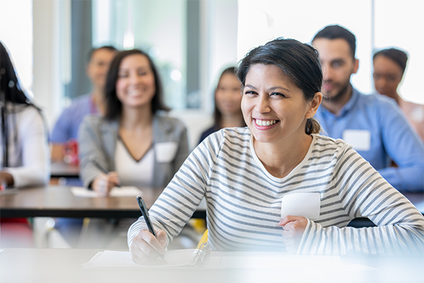 Woman smiling while attending a class.