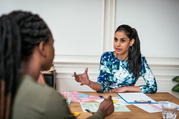 Women talking at an interview.