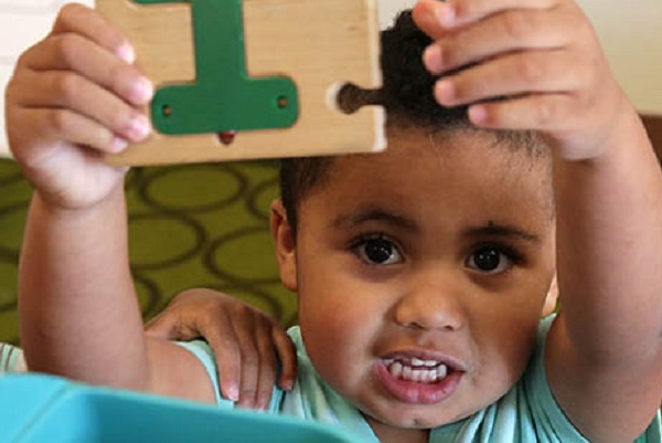 Child assembling a puzzle.