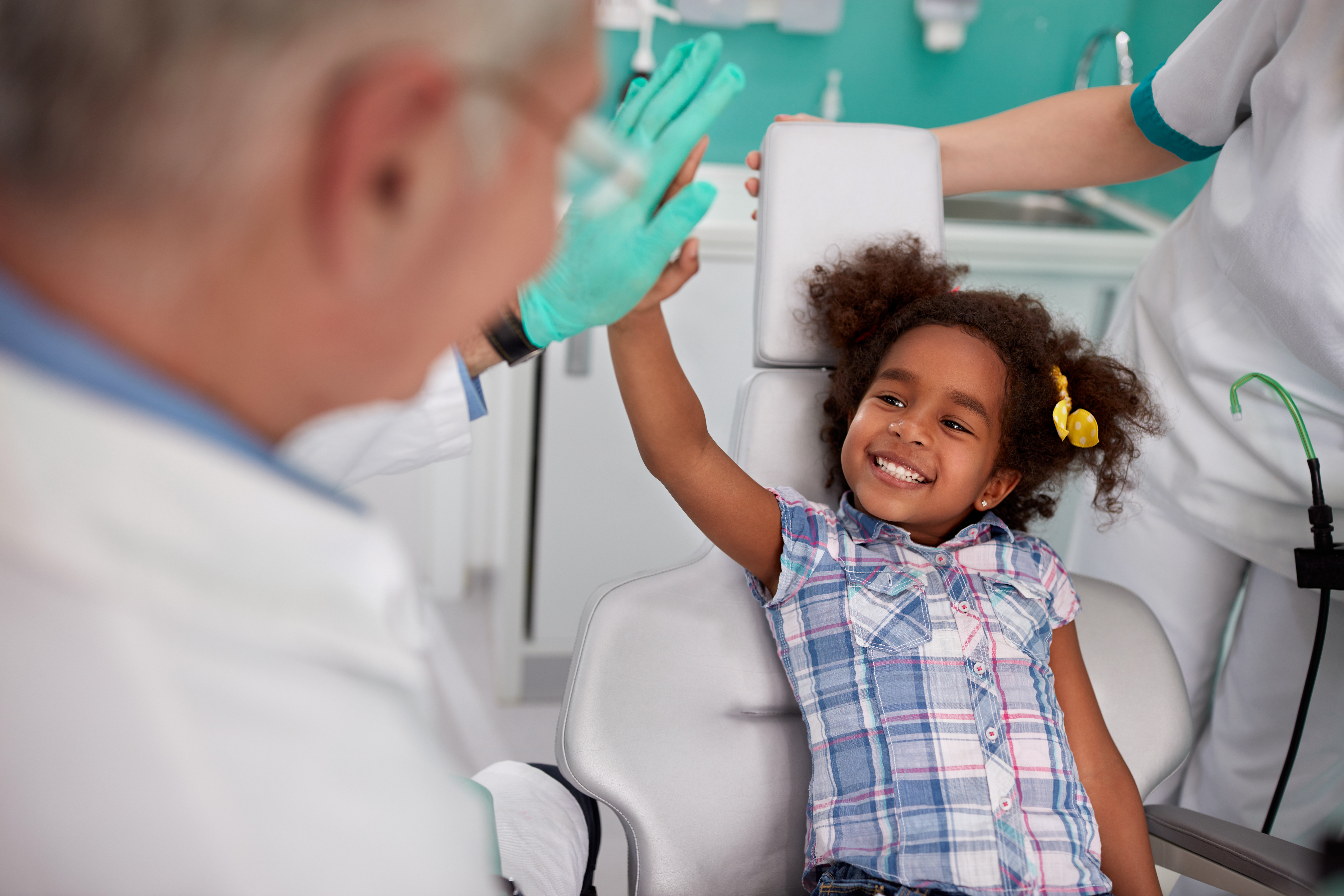 Dentist and girl share a high-five