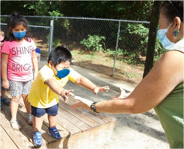 Children using masks in the playground.