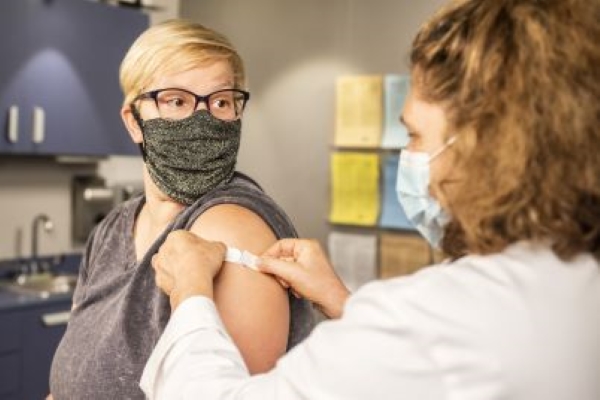 Woman getting a vaccine.