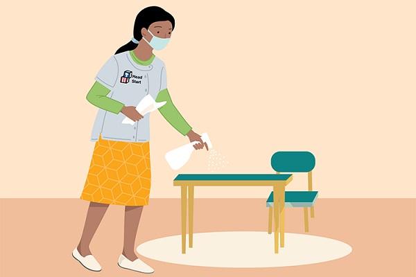 Cartoon image of a teacher sanitizing a table.