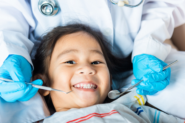 Child smiling at a dentist visit.