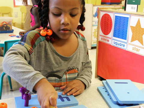 child playing with numbered blocks