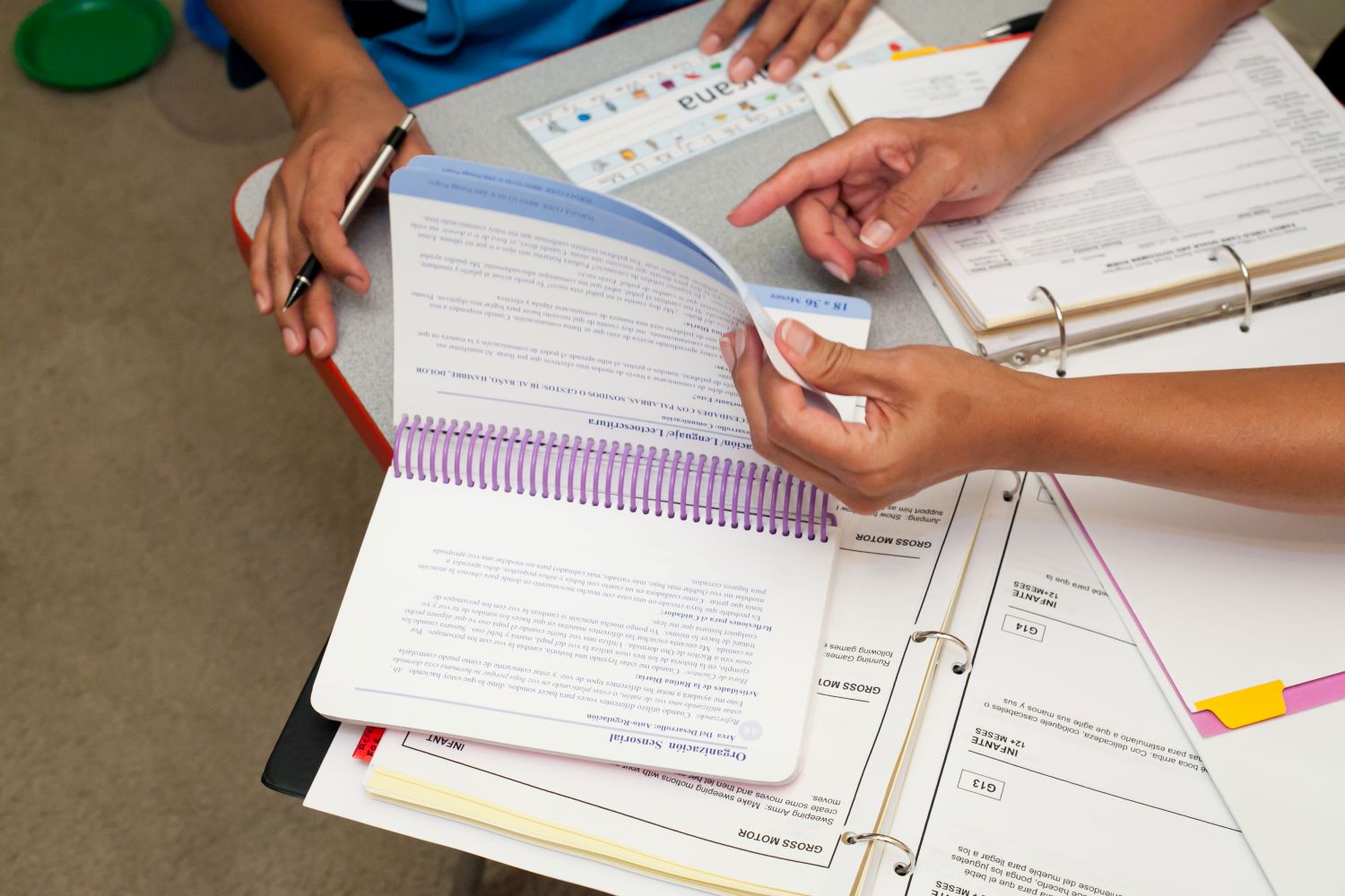 Adults going through printed resources.