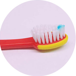 Use a smear on toothbrushes for children under age 3