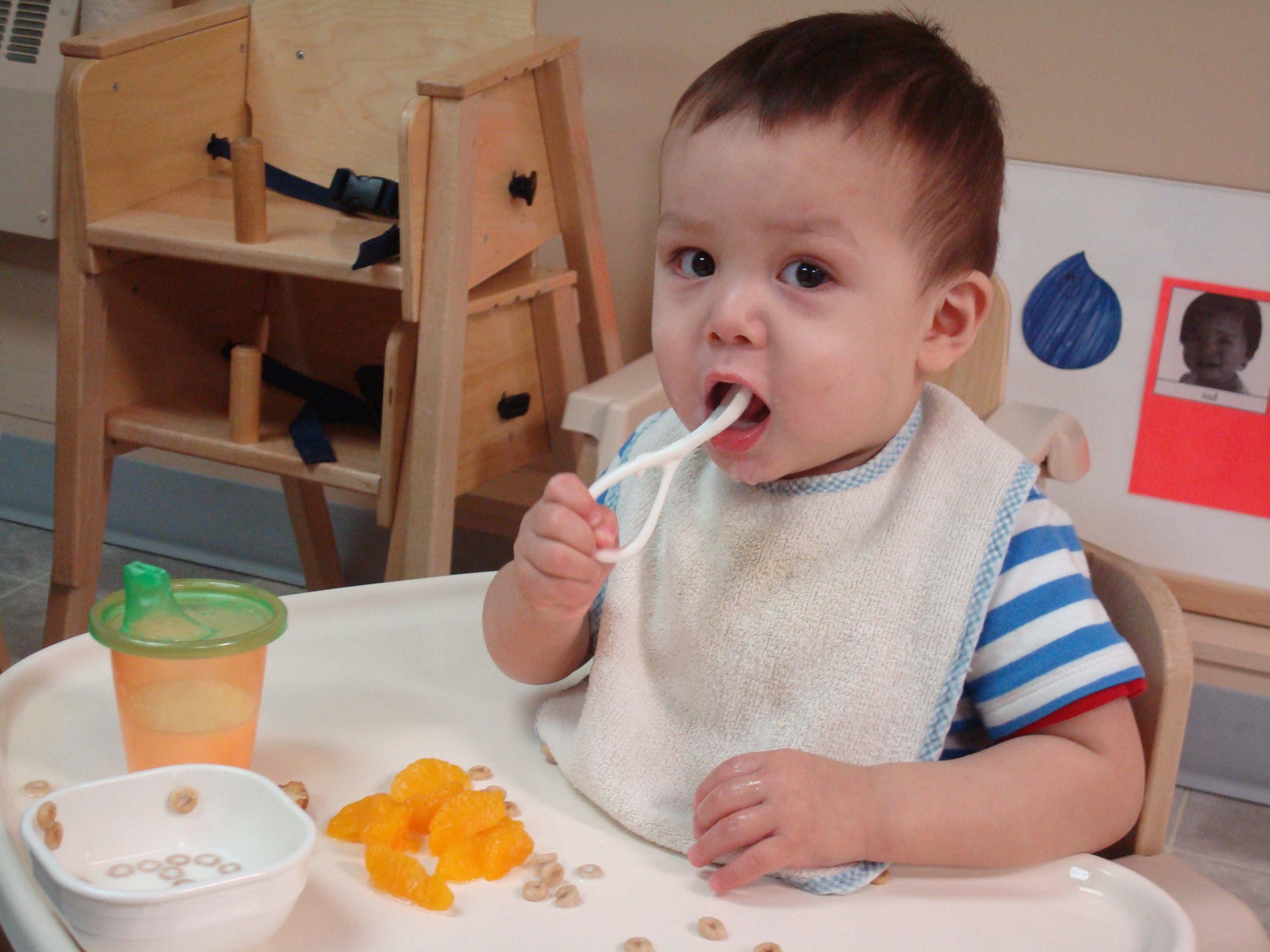 child eating in feed chair