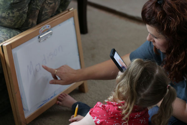 Teacher with student learning her name