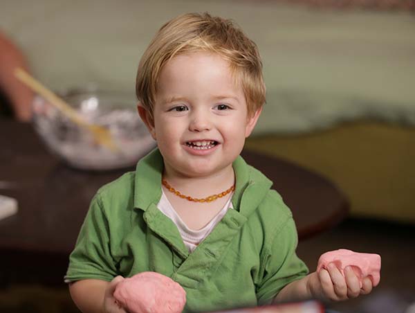 A child in a daycare setting playing with play doh