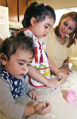 woman and children playing with clay