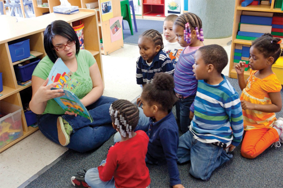 Woman reading to group of children