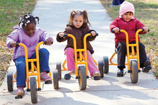 Three children on tricycles