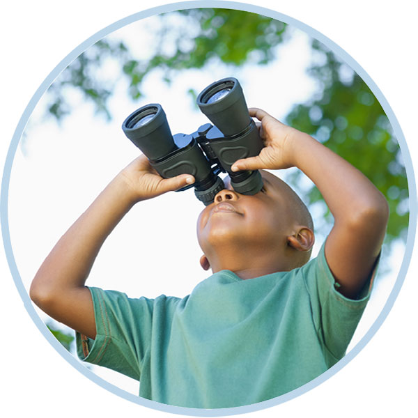 Little boy looking through binoculars