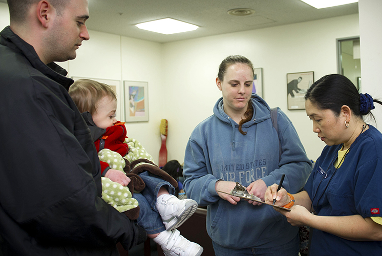 a mom, dad, and toddler visit dentist