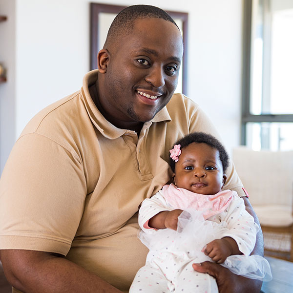 Father holding newborn daughter