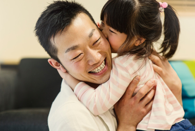 Father holding daughter