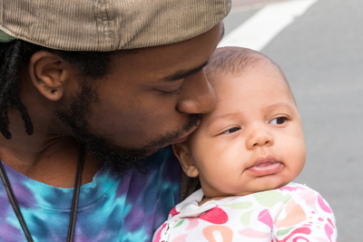 Father kissing infant on forehead