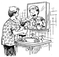 child making funny faces in a mirror with parent