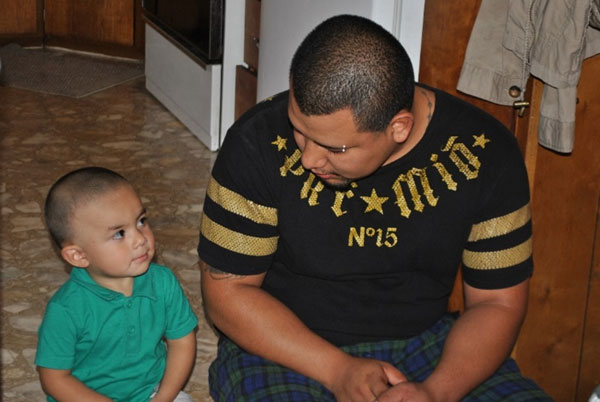 Father and son sitting on the floor