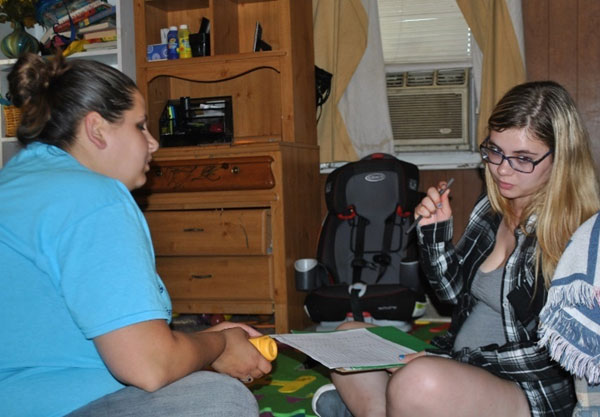 Mother and home visitor doing paperwork