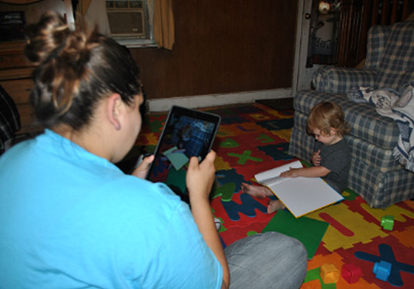 Home visitor taking video of a child