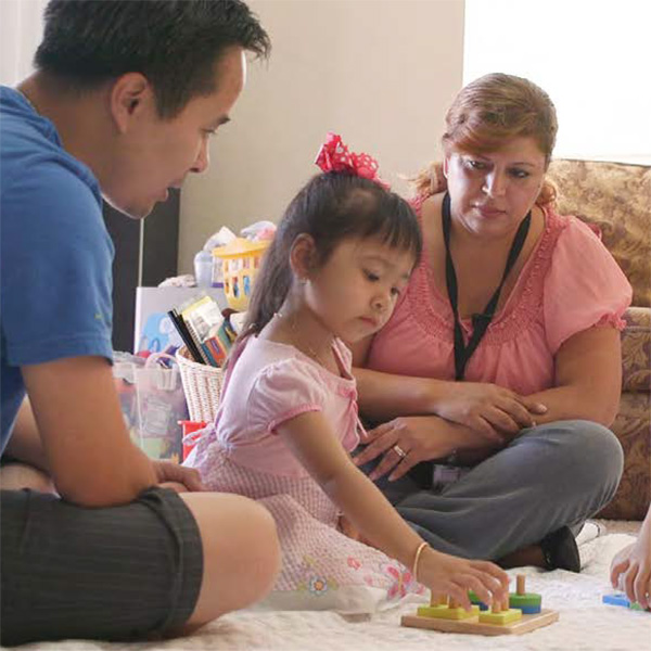 Father with his daughter and a home visitor