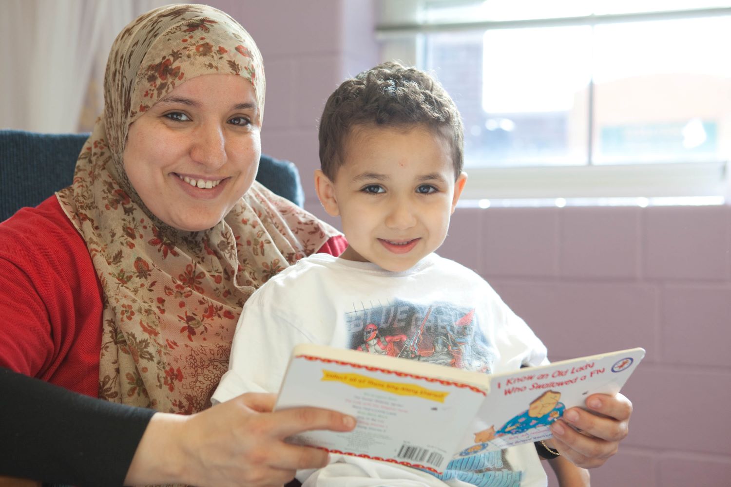 Mother and child reading a book.