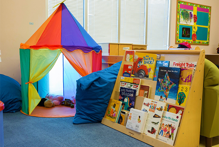 A play space with books and a tent