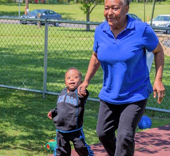 Instructor holding boy's hand