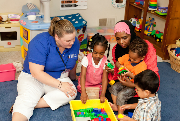 Instructors and kids playing with blocks