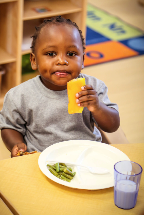 Little baby eating a healthy breakfast